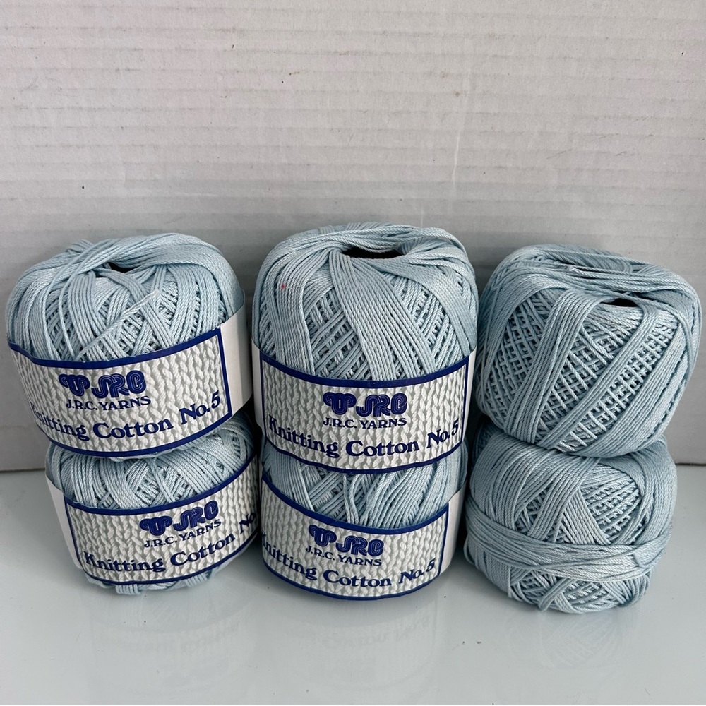 Six balls of baby blue knitting cotton yarns size 5